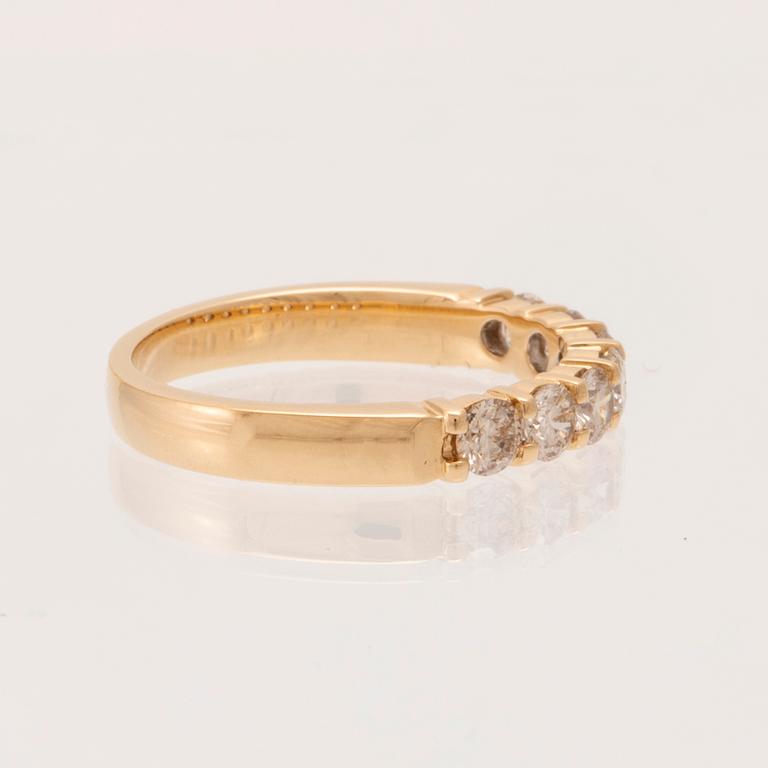 An 18K gold half-eternity ring set with round brilliant-cut diamonds.