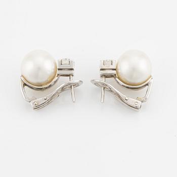 A pair of pearl and diamond earrings.