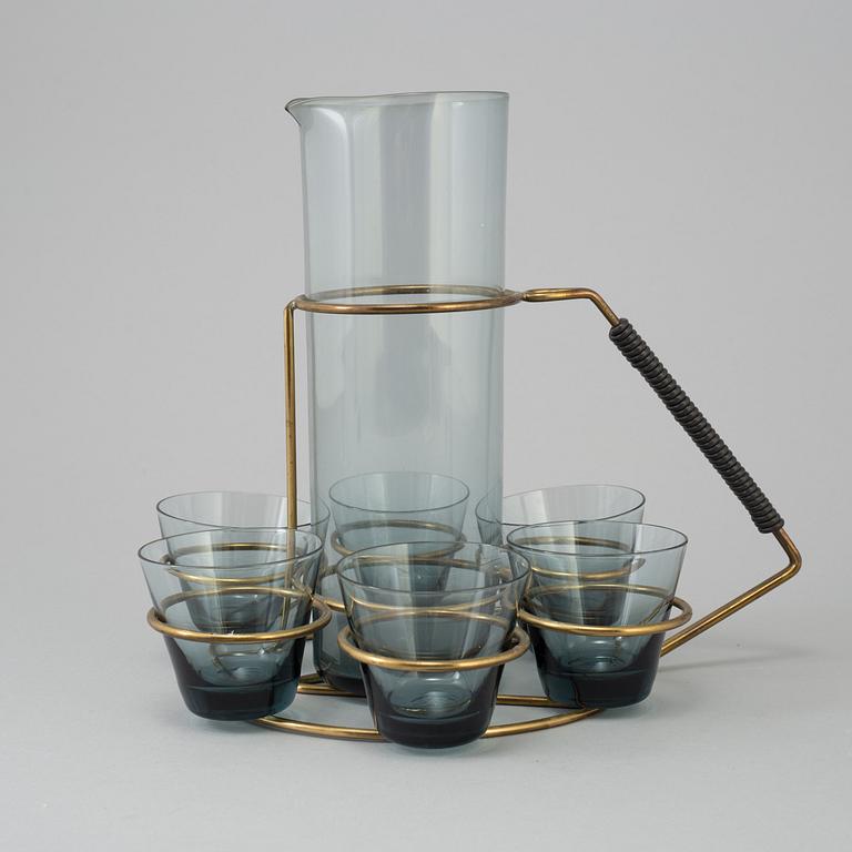 A glass pitcher with six glasses and a stand, 1950's.