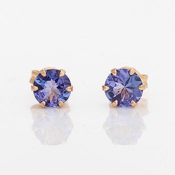 A pair of 14K gold earrings with tanzanites.