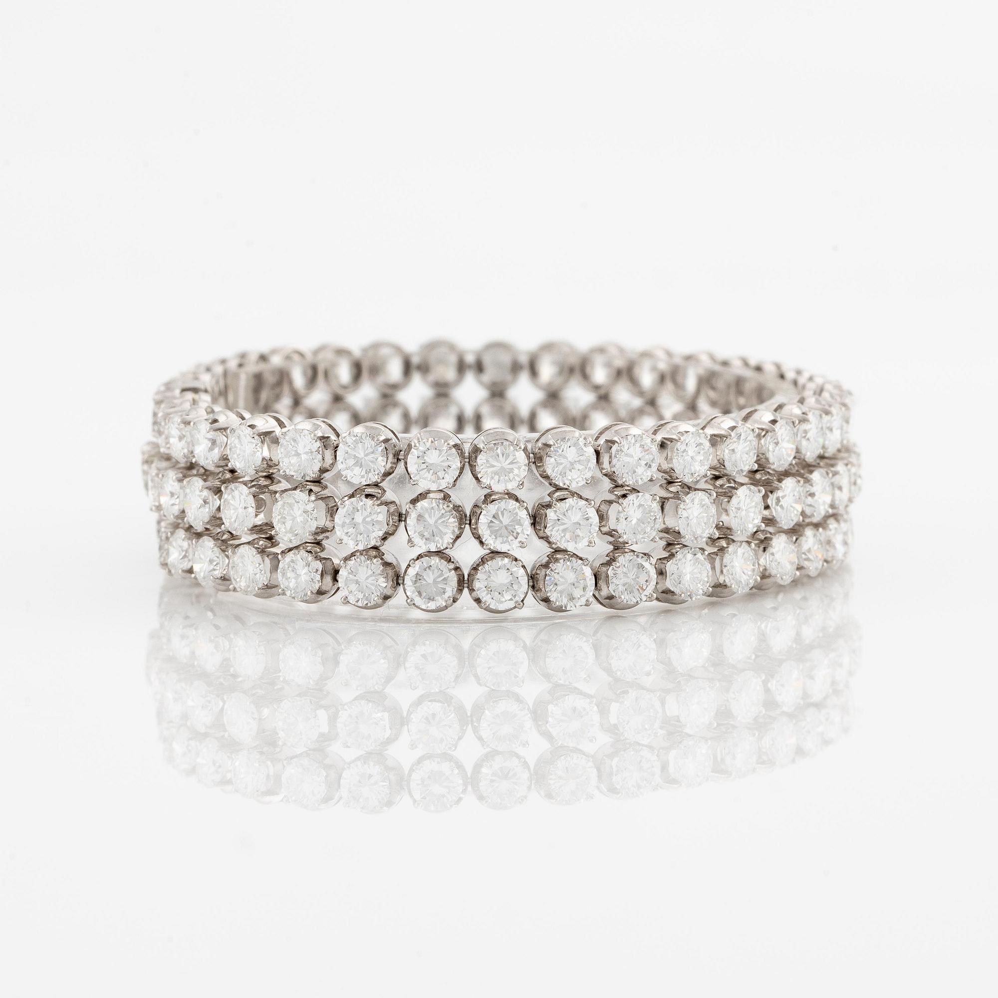A platinum bracelet set with round brilliant-cut diamonds.