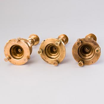 Three Russian brass candlesticks from the end of the 19th and the early 20th Century.