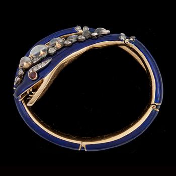 A blue enamel, moonstone, ruby and diamond bracelet in the shape of a serpent. England circa 1845.