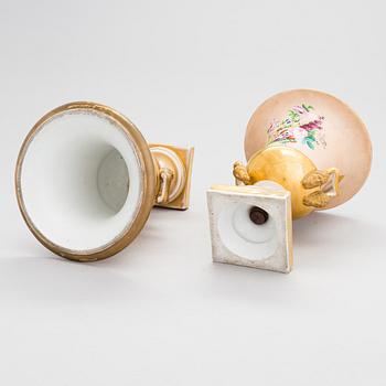 A pair of German porcelain urns from around the mid-19th century.