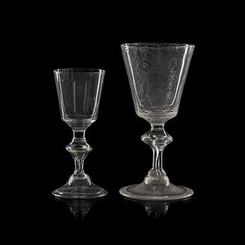 1777. A set of 16 wine glasses and 11 smaller wine glasses, the latter part of 18th Century.