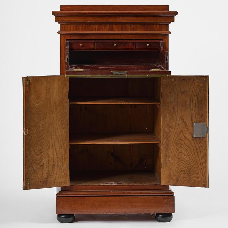 A late Gustavian mahogany column-cabinet, Stockholm, circa 1800.