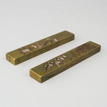 A pair of Japanese scroll weights, early 20th Century.