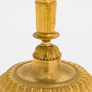 A pair of mid-19th-century gilded bronze candlesticks.