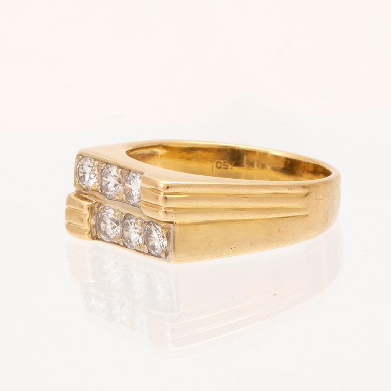 An 18K gold ring set with round brilliant cut diamonds.