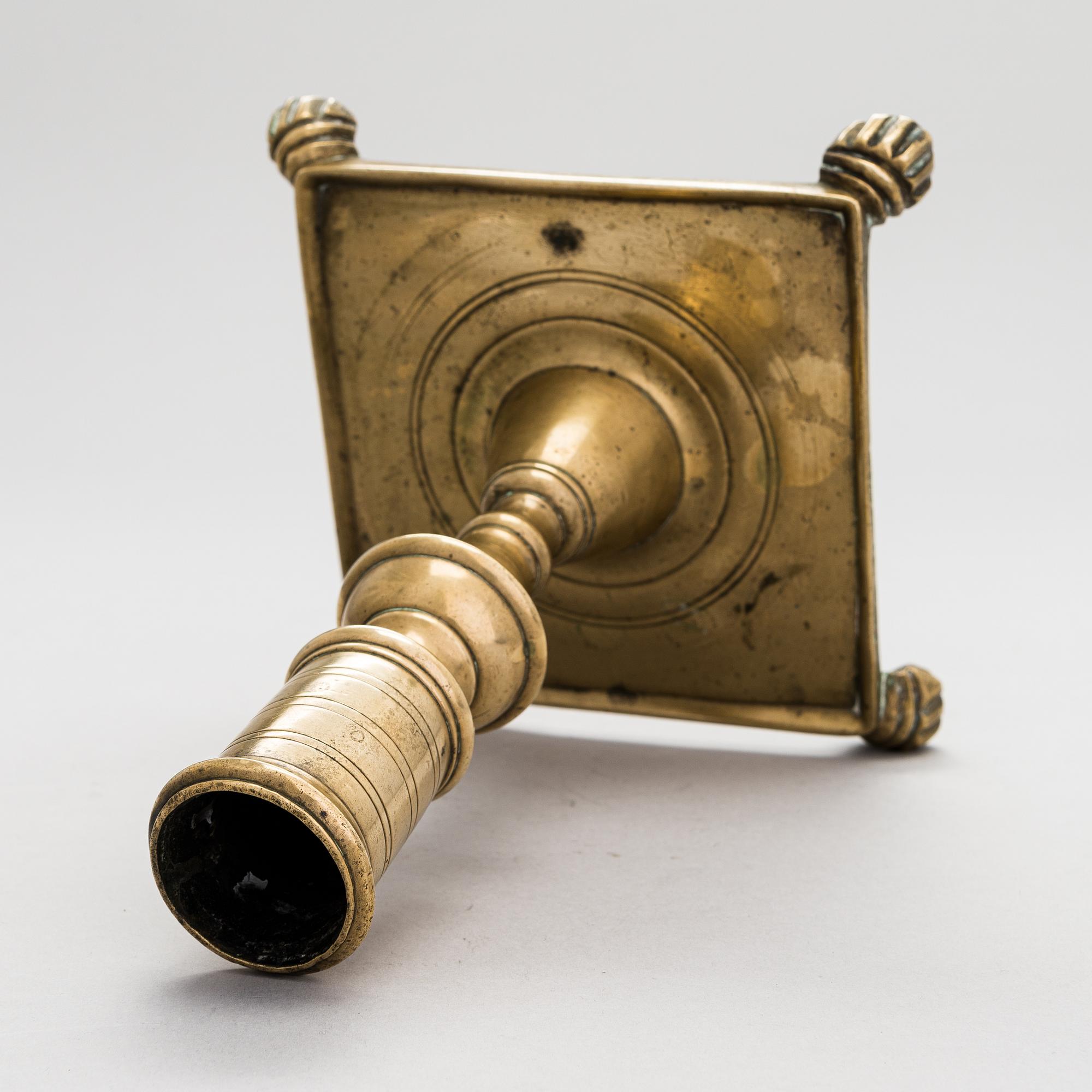A late 17th century Spanish brass candlestick.