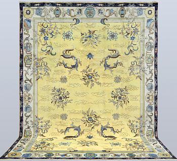 A Tabriz carpet, signed, approx. 388 x 280 cm.