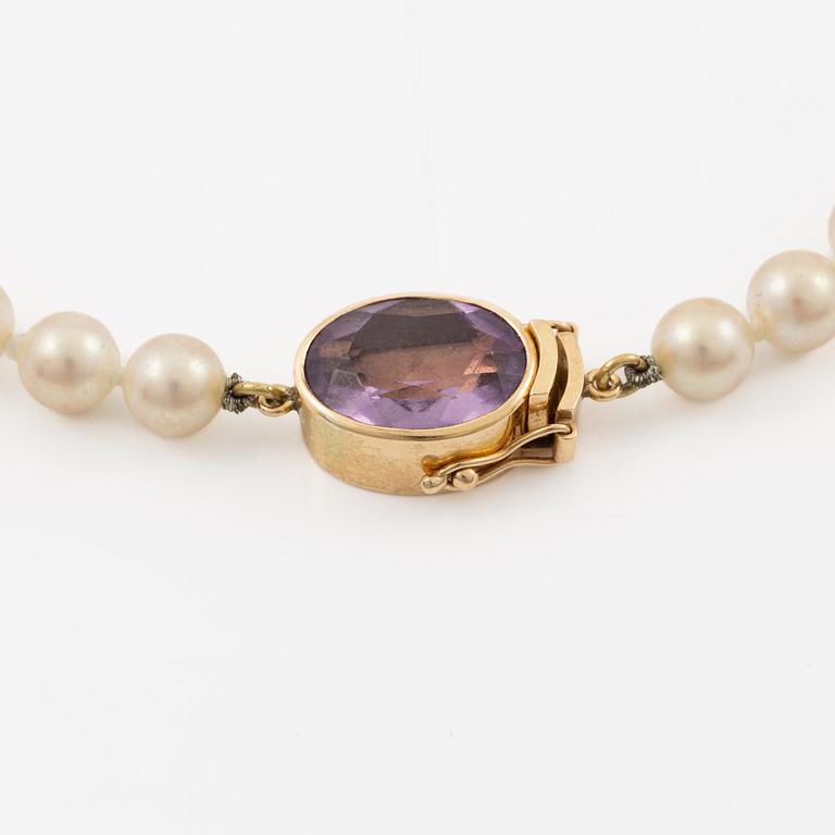 Necklace with imitation pearls, clasp 18K gold with amethyst, spacers 18K gold with pearls and diamonds.