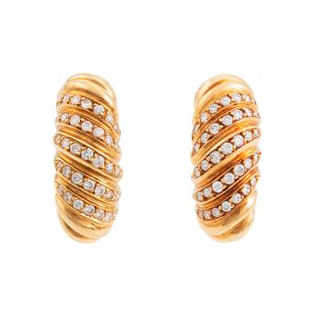 472. A pair of Cartier earrings in 18K gold set with round brilliant-cut diamonds.