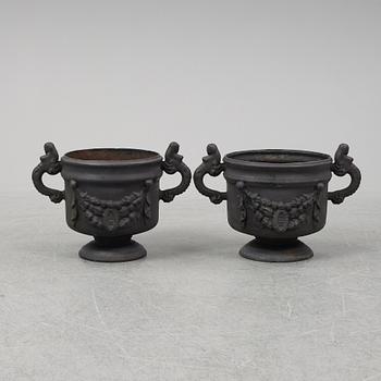 Two 20th Century cast iron flower pots.