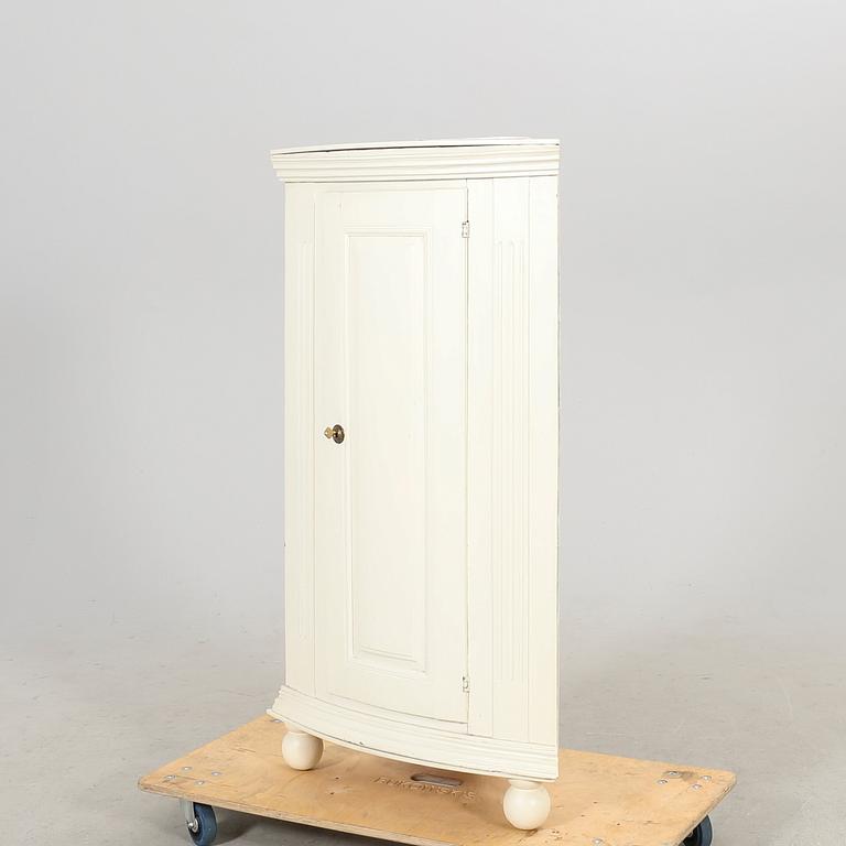 A painted 19th century corner cabinet.