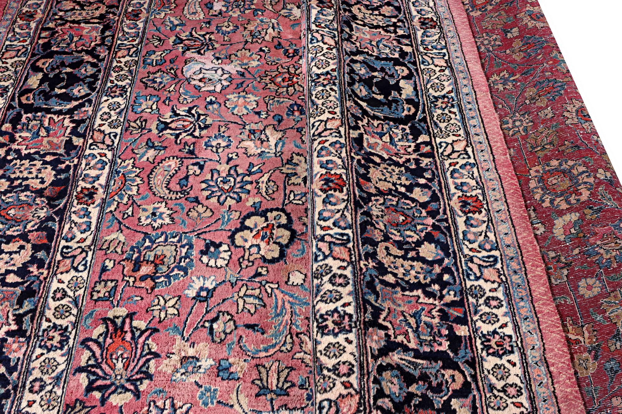 An antique Mashad carpet, signed Saber, c. 405 x 295 cm.