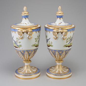 A pair of French 19th century porcelaine 
lidded vases with Sèvres style mark.