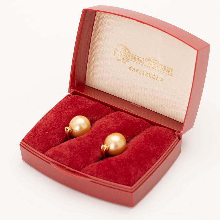18K gold earrings with South Sea pearls and diamonds.
