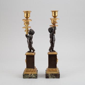 A pair of bronze empire style candleabra, 20th century.