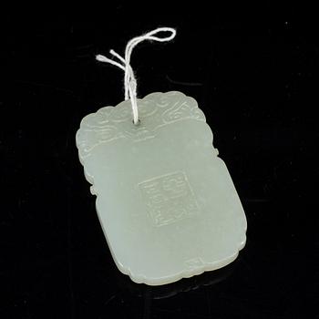 A carved nephrite pendant, 20th Century.