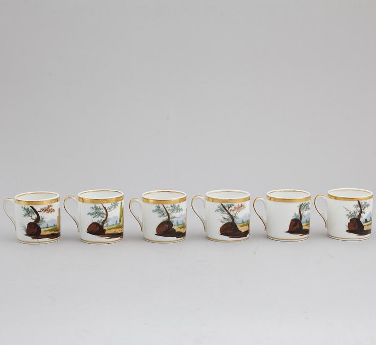A group of seven cups, one with dish, Germany and France, 19th century.