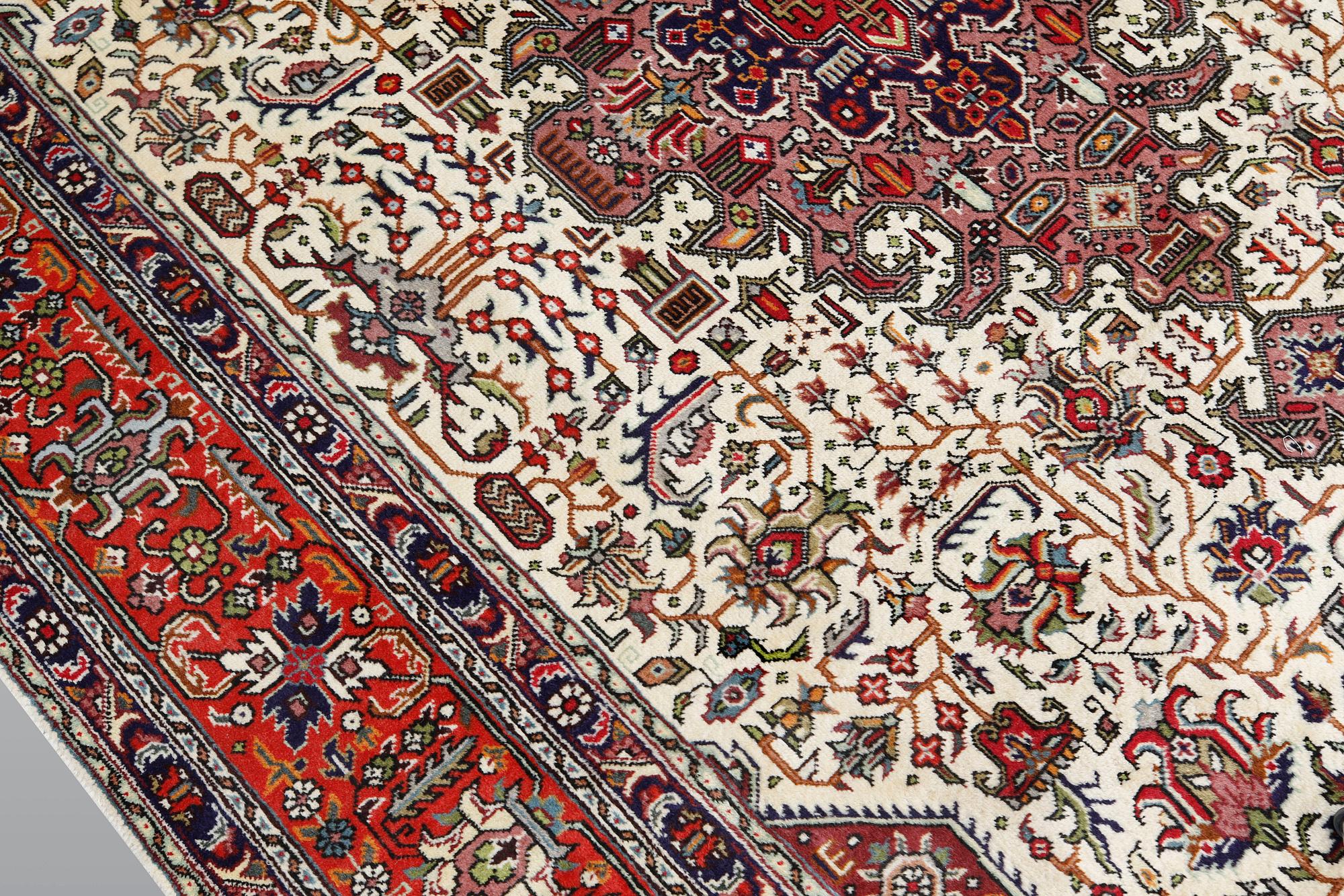 A Tabriz carpet, approximately 298 x 198 cm.