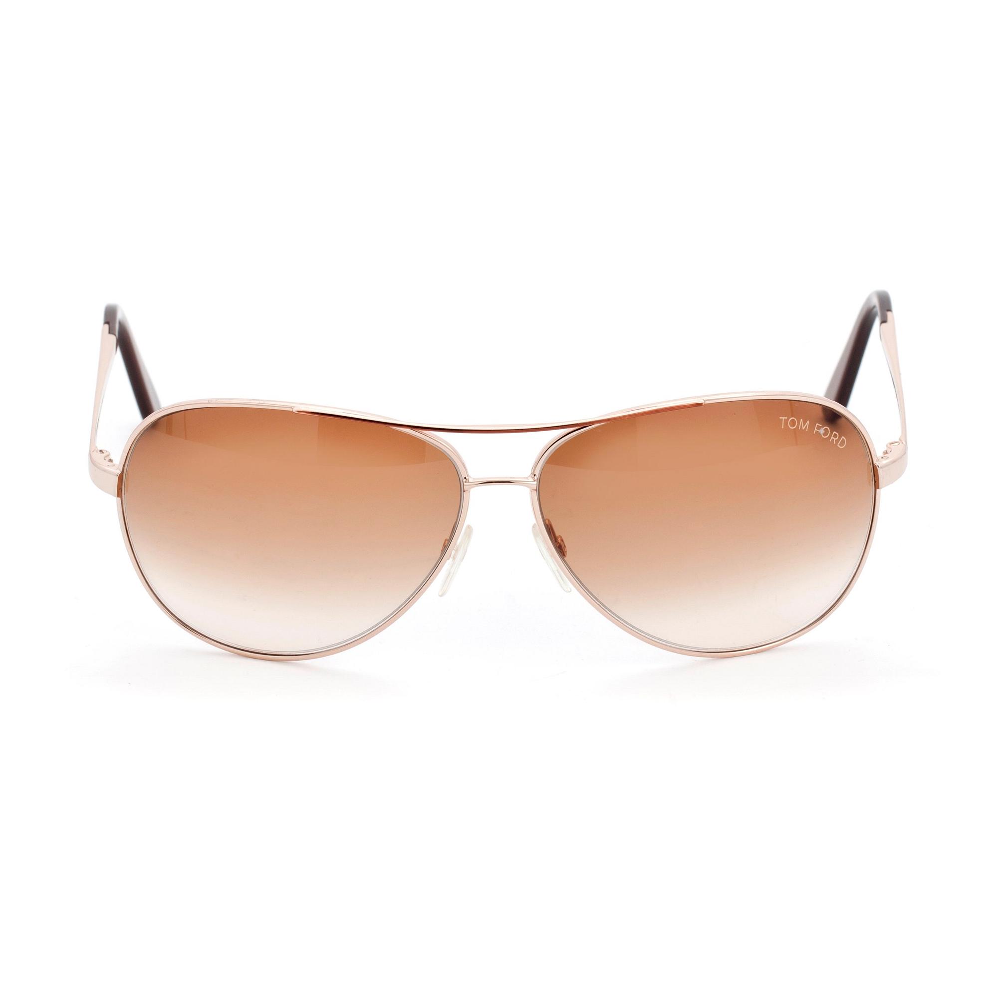 TOM FORD, a pair of gold colored sunglasses.