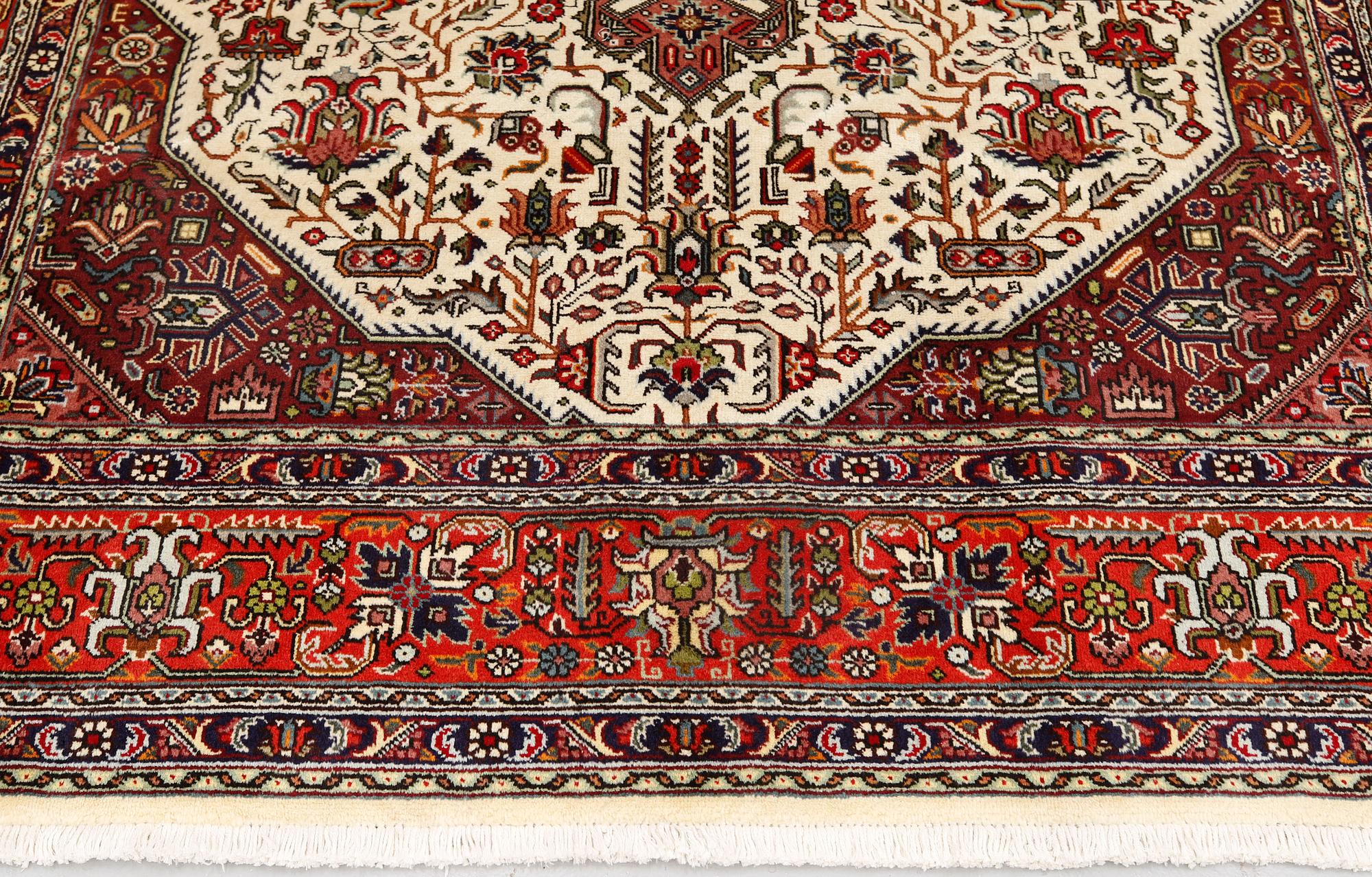 A Tabriz carpet, approximately 298 x 198 cm.