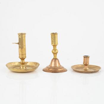 Five brass candlesticks, 18th century.