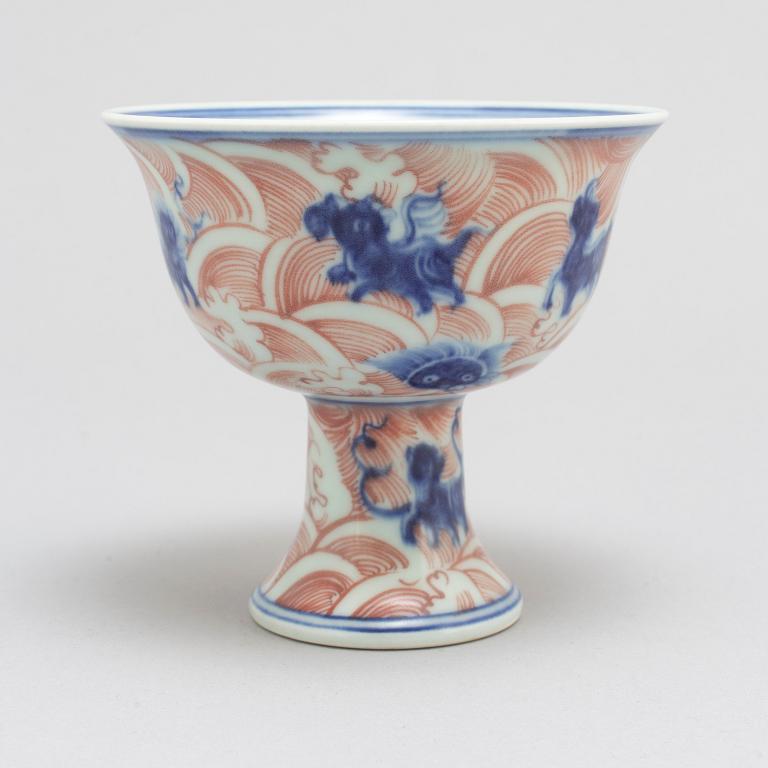 A Chinese ironred decorated blue and white 'Mythical sea creature' stem cup, 20th century.