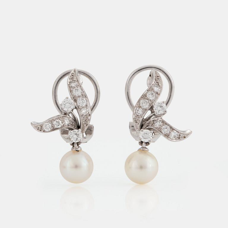 A pair of earrings set with eight- and round brilliant-cut diamonds and cultured pearls.