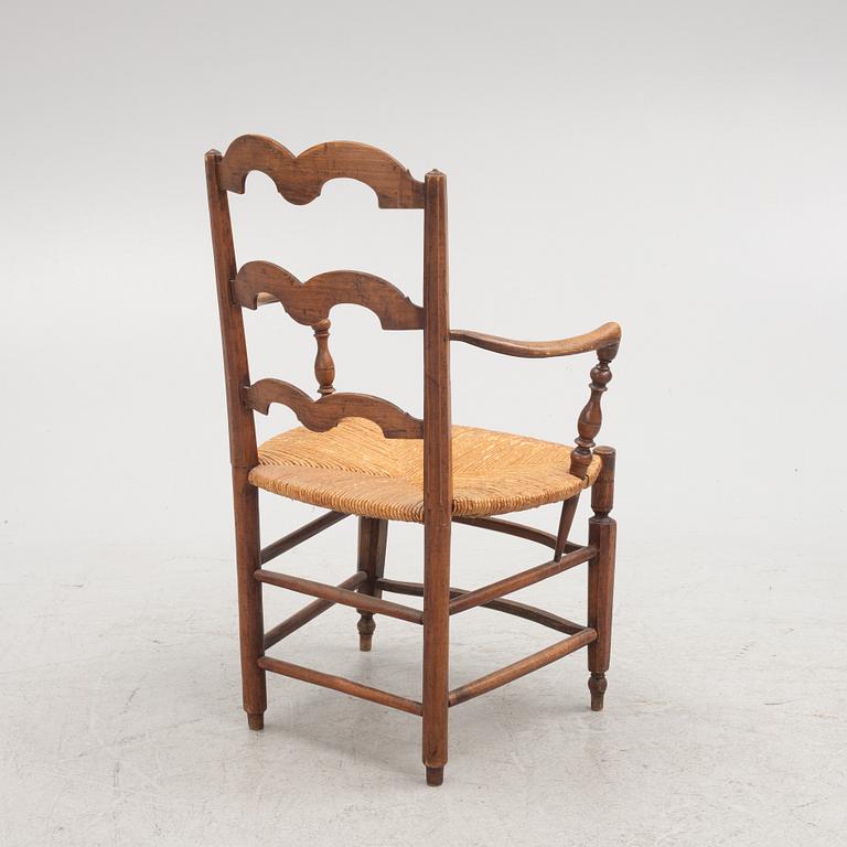 A French walnut open armchair, first part 19th century.