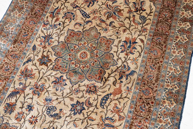 A semi-antique silk Isfahan rug, Central Persia, signed (Sadegh) Seirafian, c. 209 x 142 cm.