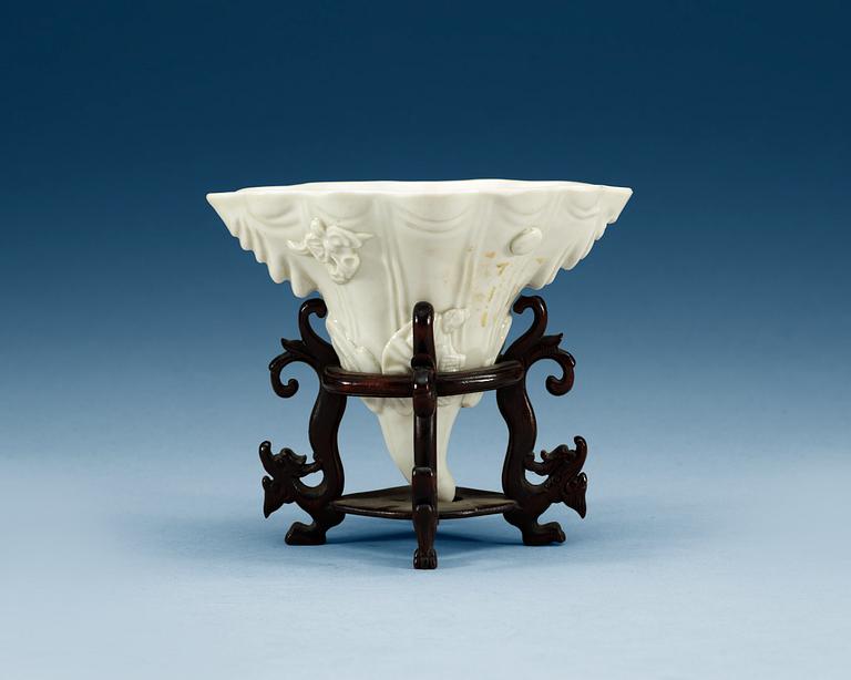 A blanc de chine libation cup in the shape of a rhinoseroushorn, Qing dynasty, Kangxi (1662-1722).