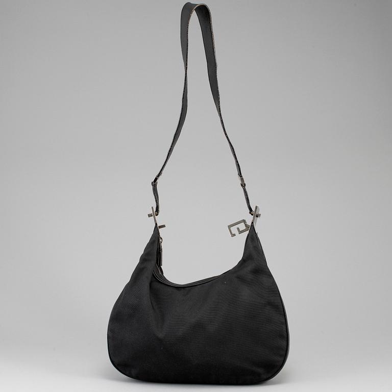 GUCCI, a canvas handbag.