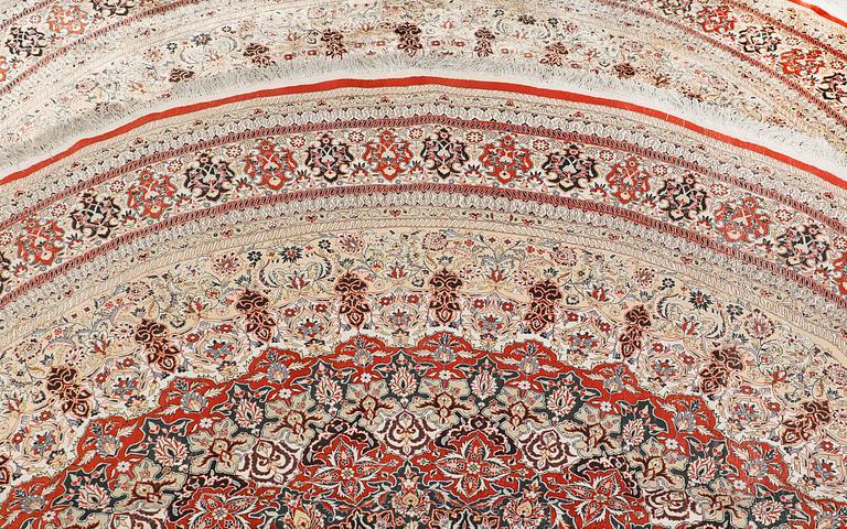An Oriental silk rug, diameter 256 cm.