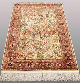An Oriental figural silk rug, ca 126 x 83 cm.