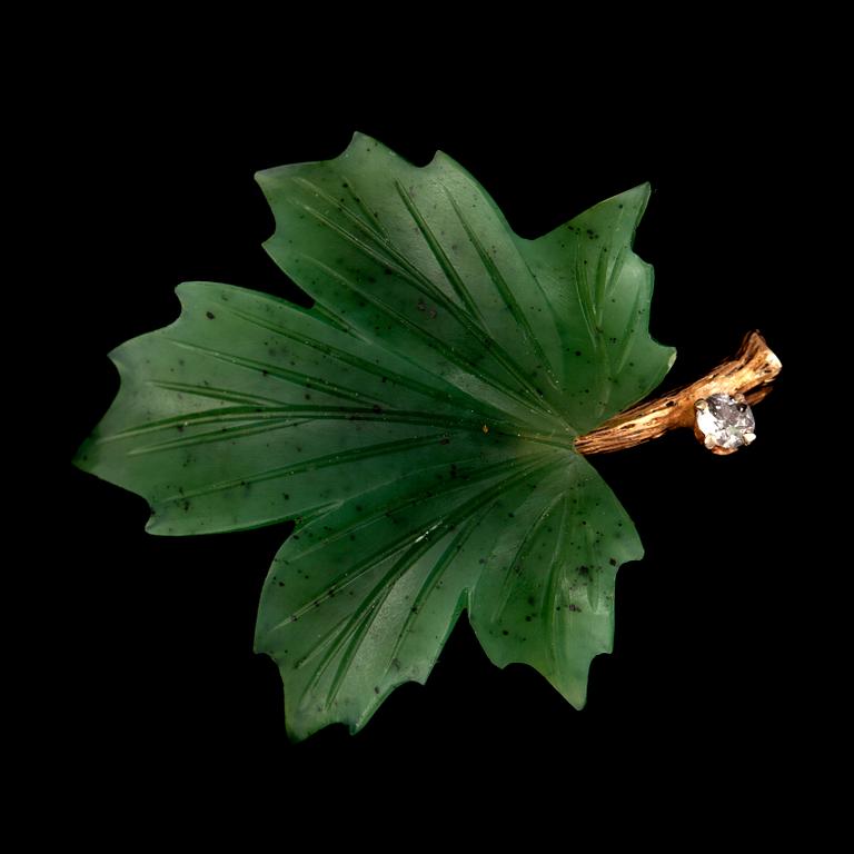 A nephrite and diamond brooch in the shape of a maple leaf. Weight of diamond 0.10 ct.