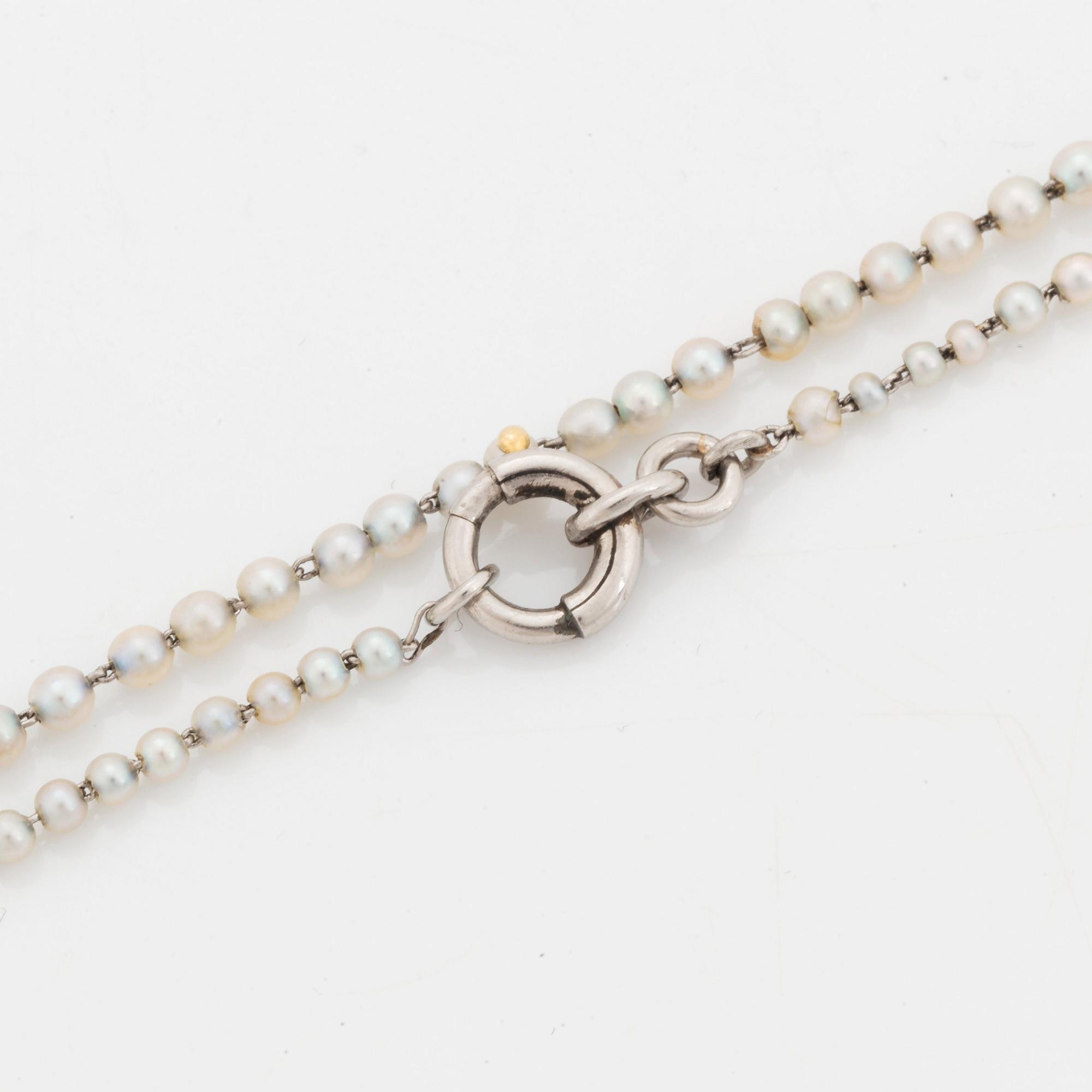 A platinum lorgnette set with a faceted sapphire and rose-cut diamonds.