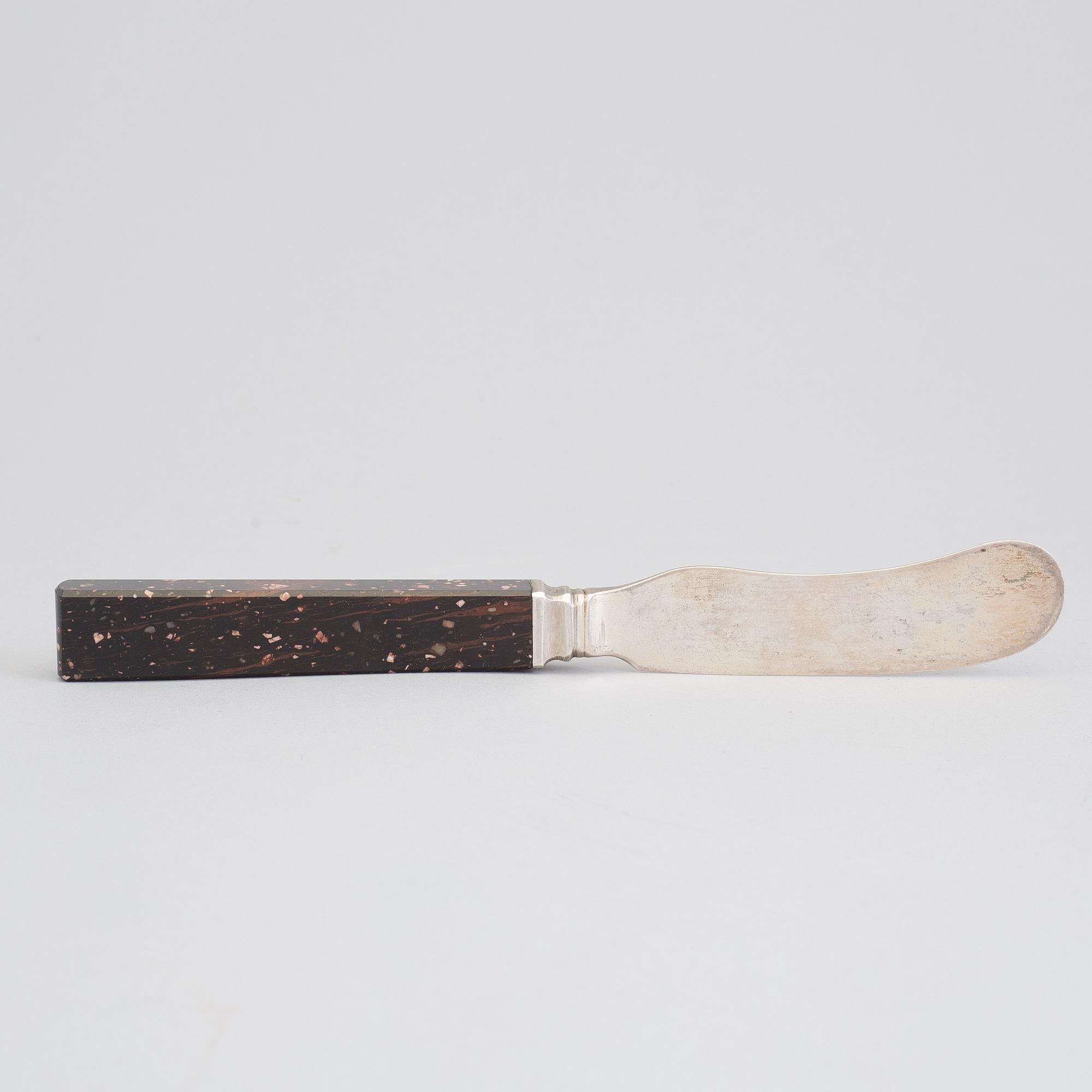 A silver butterknife with porphyry shaft, dated 1853.