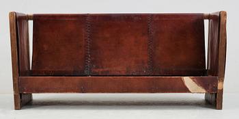 An Axel Einar Hjorth 'Funkis' brown leather and stained wood sofa, Nordiska Kompaniet, Sweden 1930's.