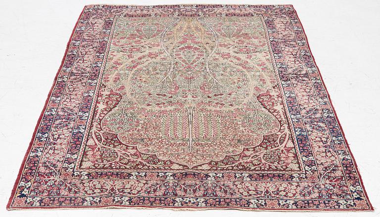 An antique Kirman rug, south Persia, c. 220 x 140 cm.
