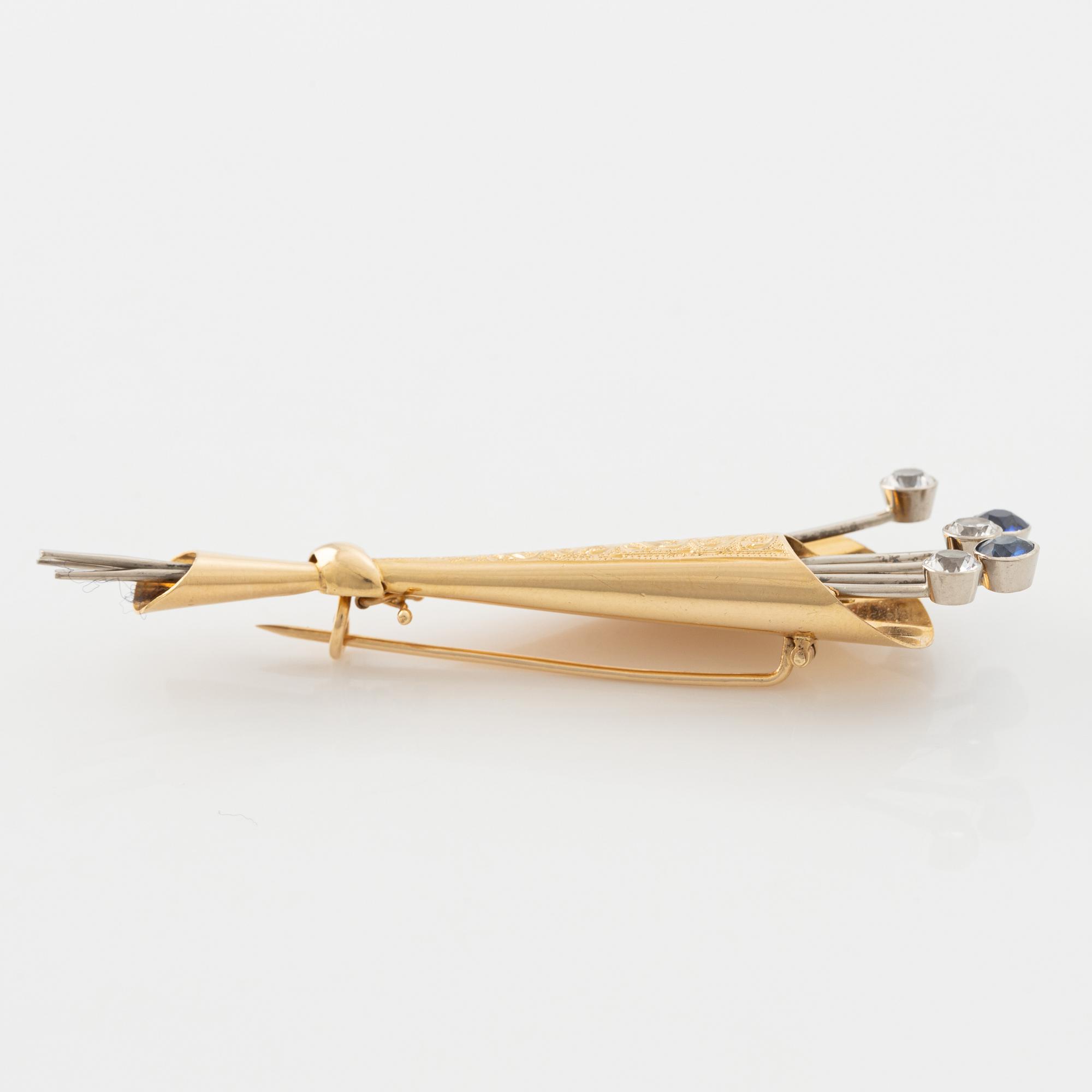 18K gold, white and blue sapphire brooch.