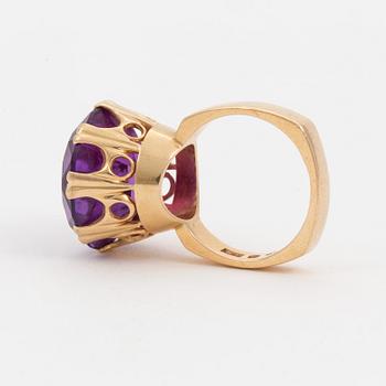 A ring set with a synthetic, purple sapphire.