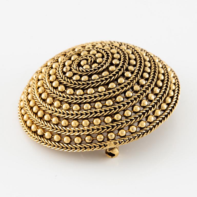 Christian Dior, A gold tone domed vintage brooch, 1963.