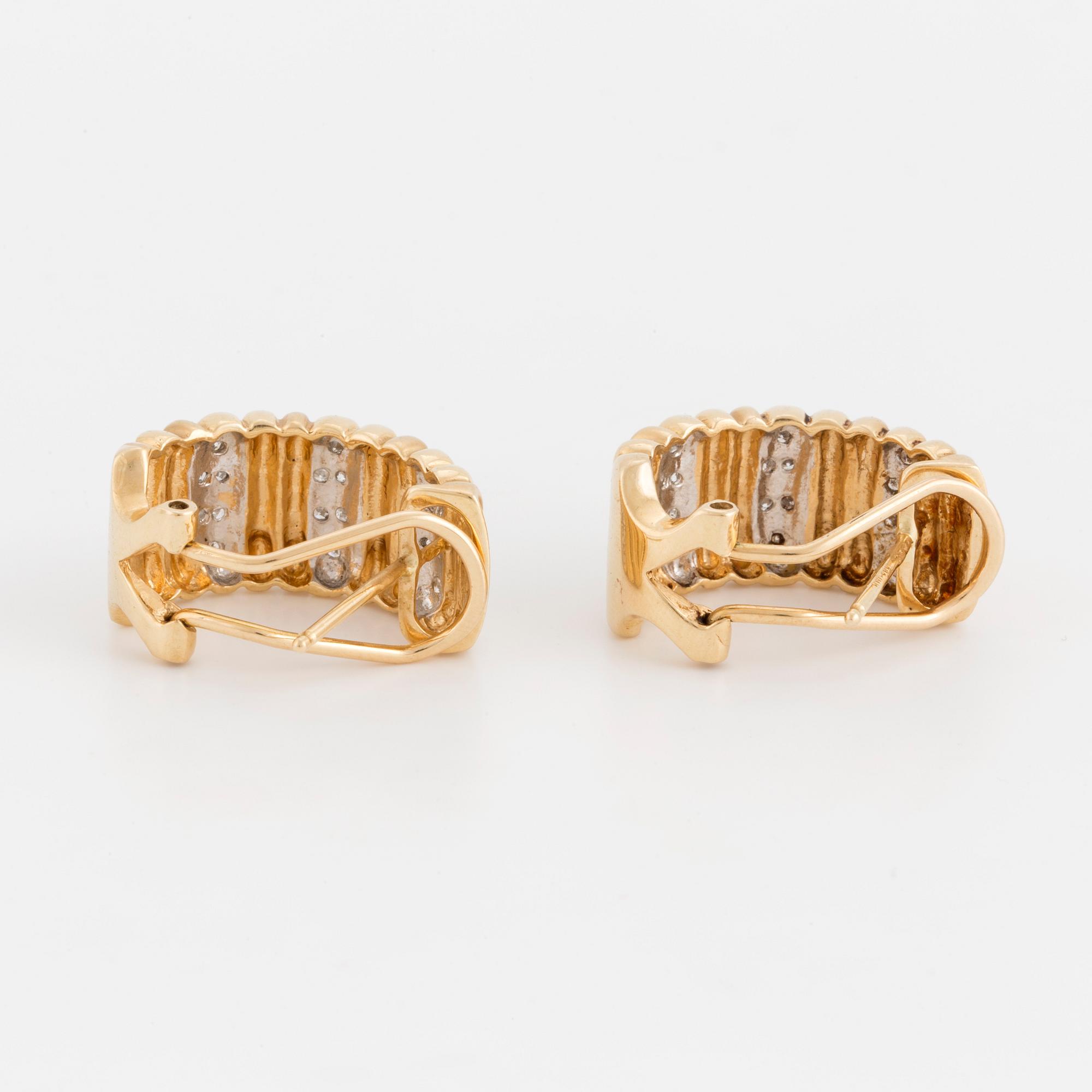 A pair of earrings set with eight-cut diamonds.