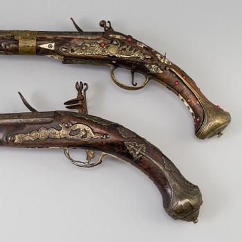 Two 19th century flintlock pistols.