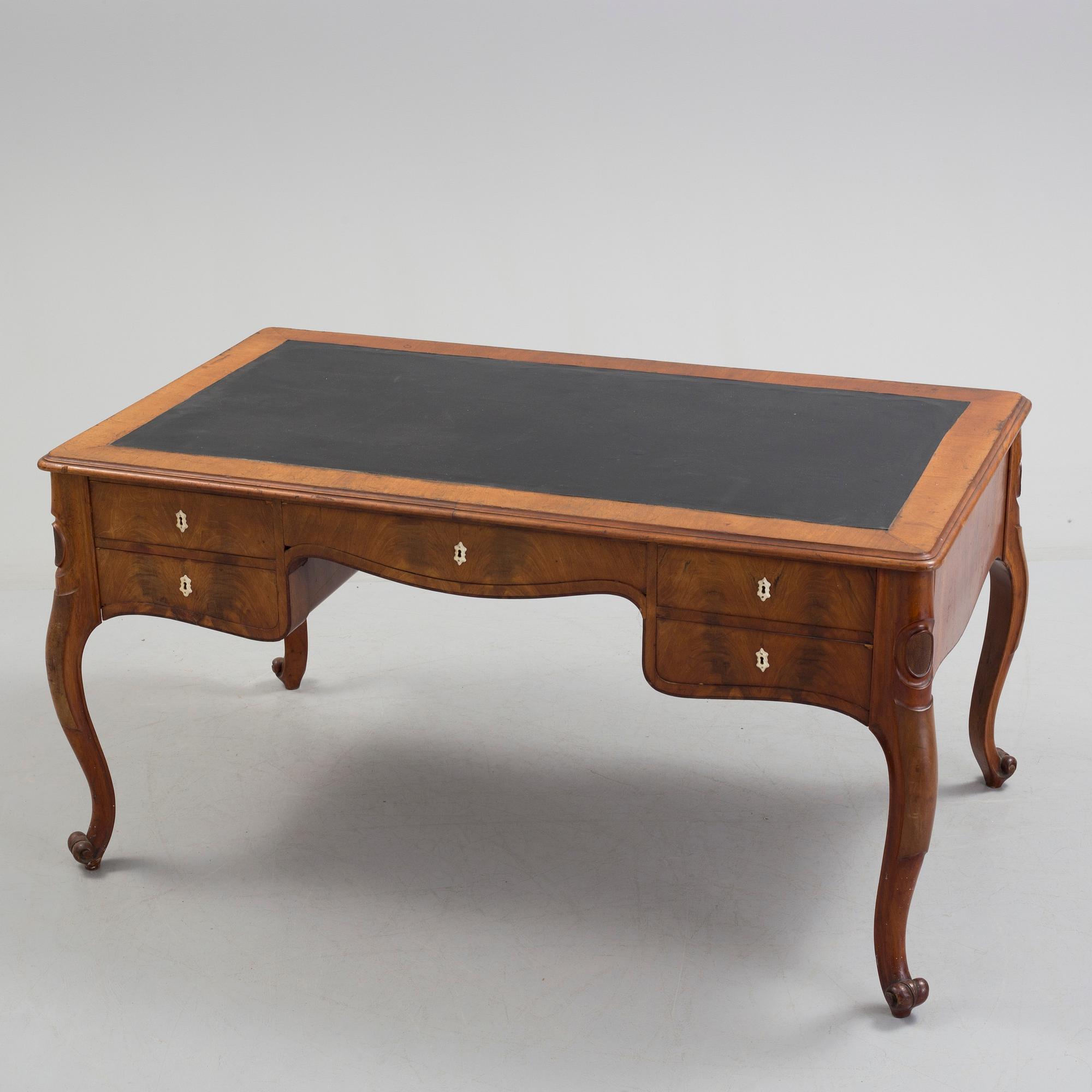 a mahogany rococo-style desk from the second half of the 19th century.