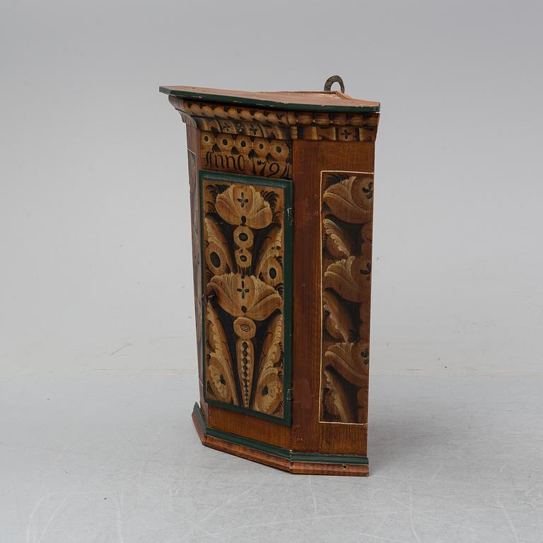 A painted corner cabinet, dated 1794.