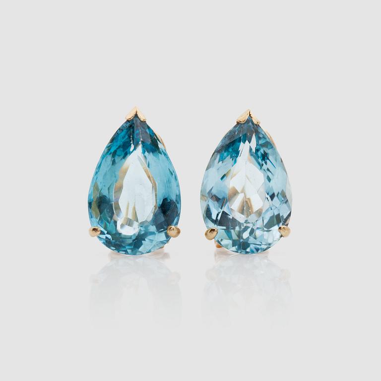 A pair of pear-shaped aquamarine earrings.